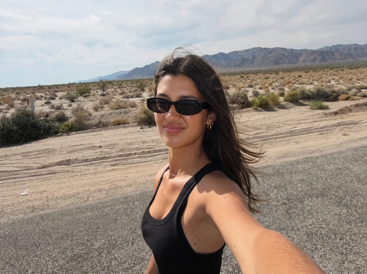 Chiara taking a selfie in sunglasses in the desert