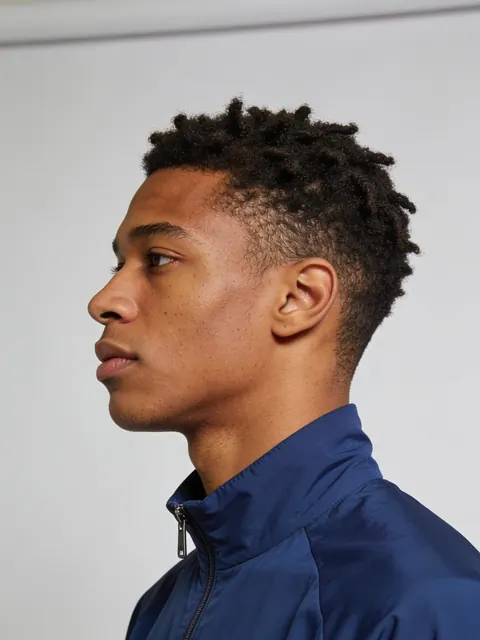 Generated studio portrait, a young man in a blue track jacket